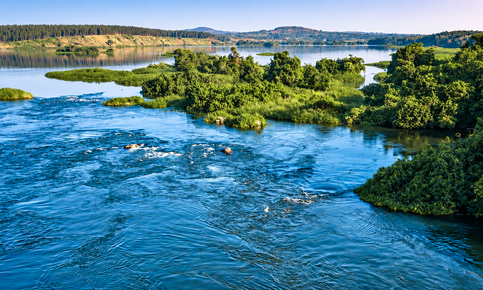 Blue river waters flowing past lush green islands in Uganda